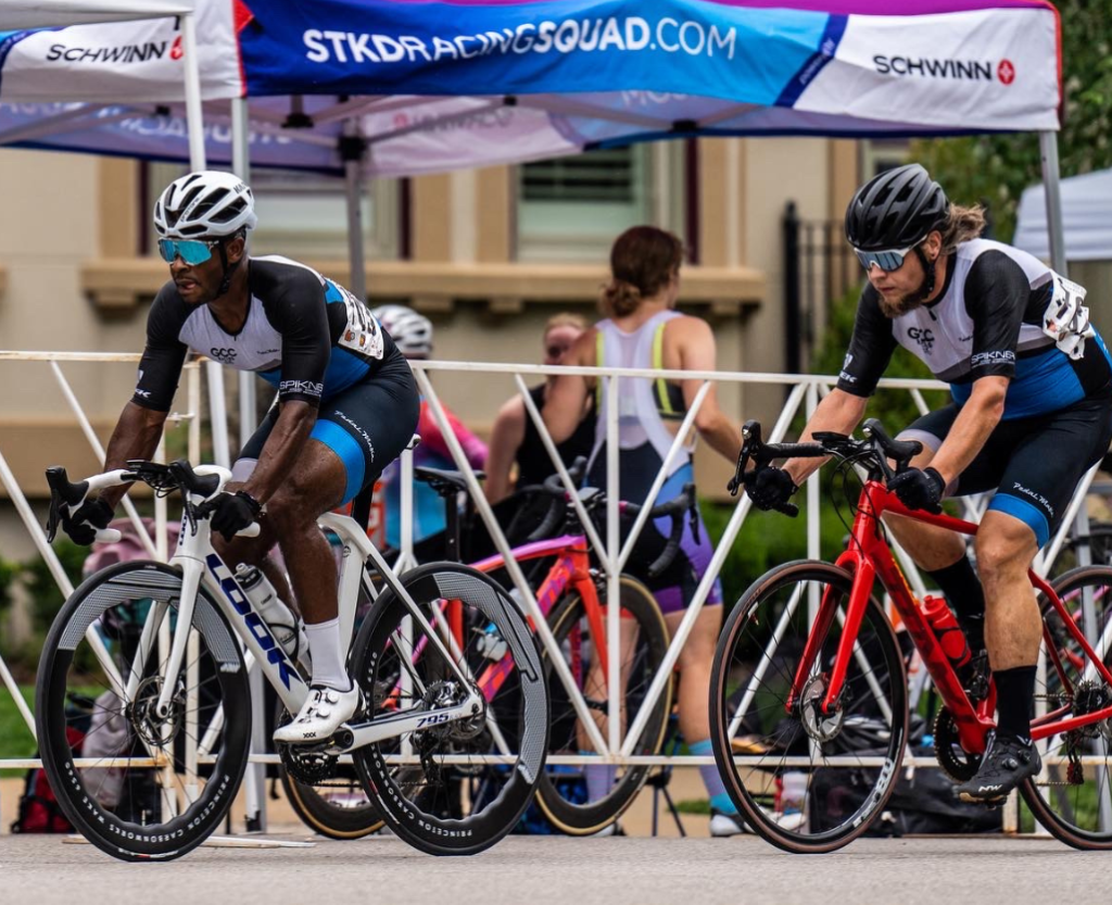 A vibrant image of a bicycling team mid-race, with each member closely following the other in a tight formation.